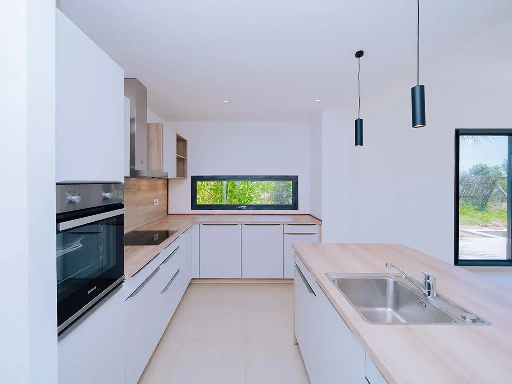 Interior kitchen with wood flooring and modern appliances in 3BR townhouse Zanzibar Tanzania